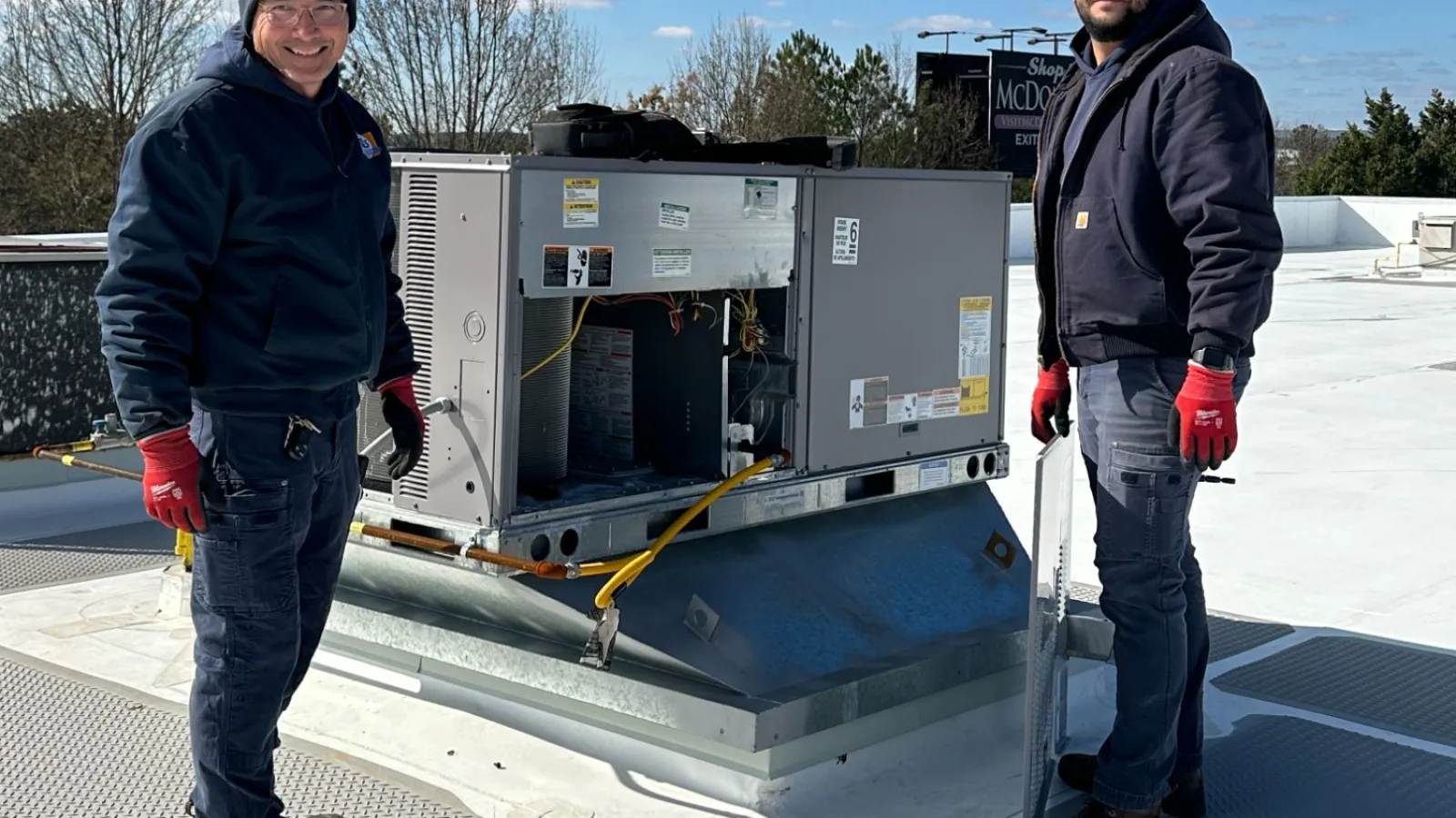 HVAC technician working on commercial rooftop unit